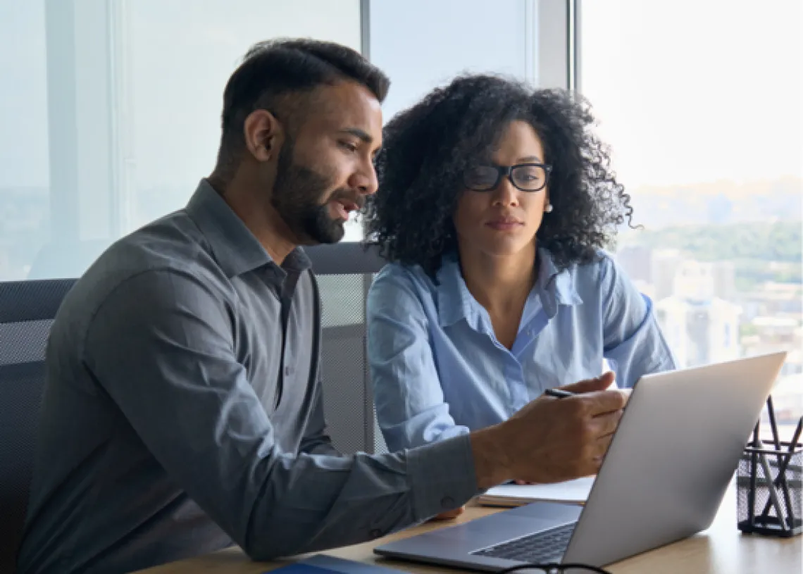 Two people working together on a computer