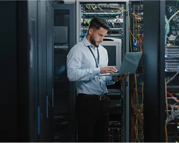 Man in server room on laptop