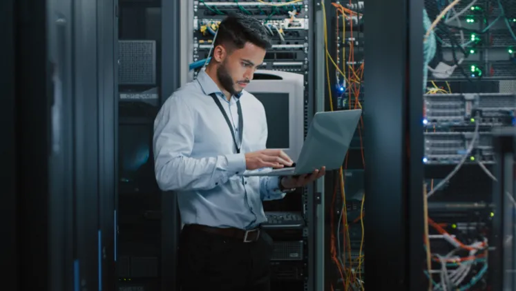 Man in server room on laptop